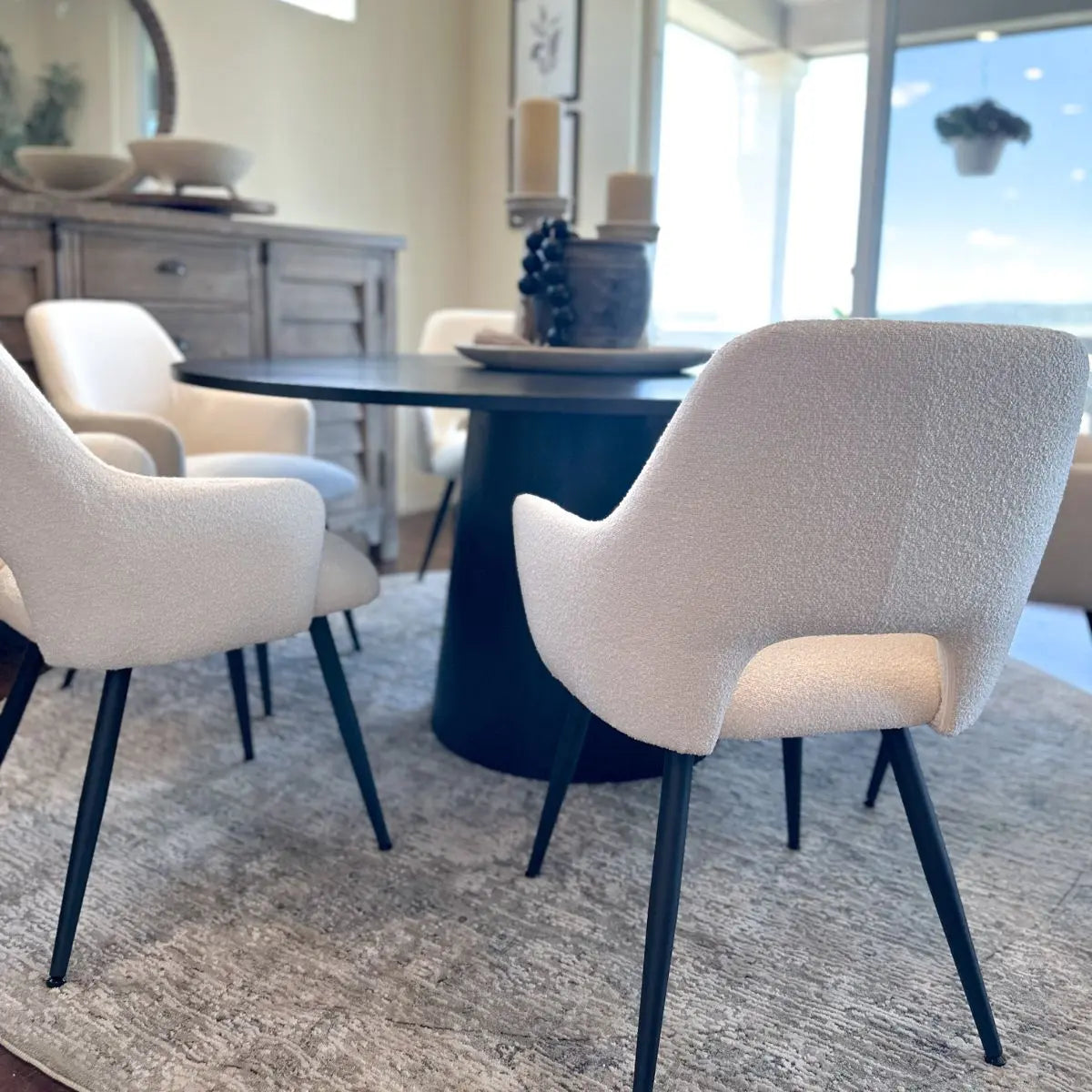 Edwin Modern Upholstered Dining Chair with Arms in elegant dining room, round table, neutral decor.