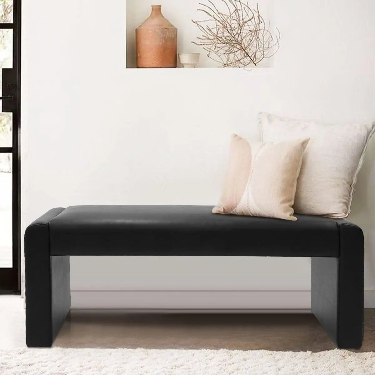 Kaia Modern Leather & Velvet Waterfall Bench in minimalist room with neutral wall, plush rug.