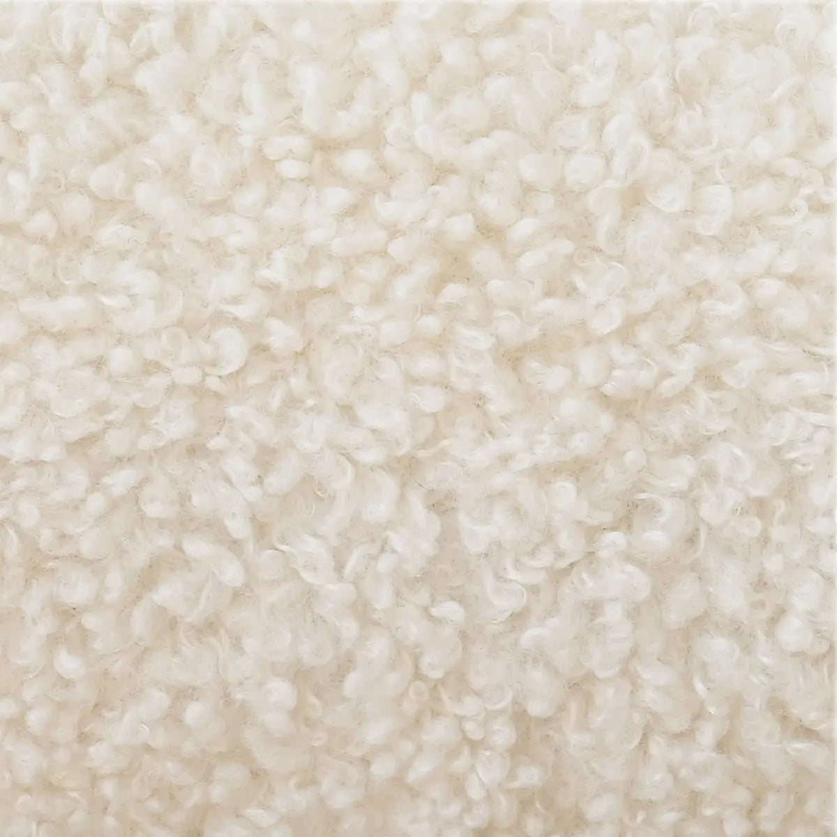 Close-up texture of beige boucle fabric on Maye living room chair upholstery.