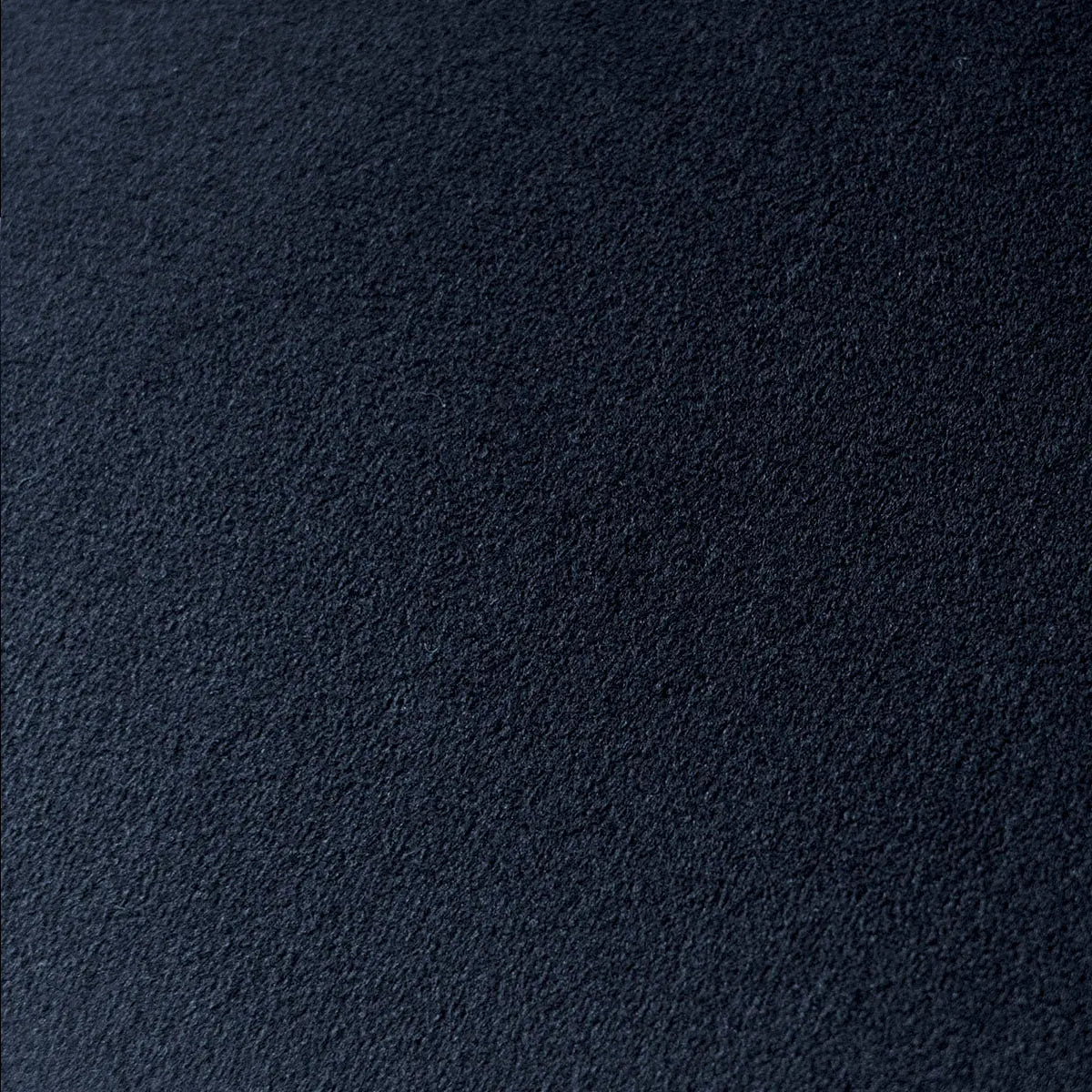 Dark textured surface seen up close. No visible furniture or decor elements.