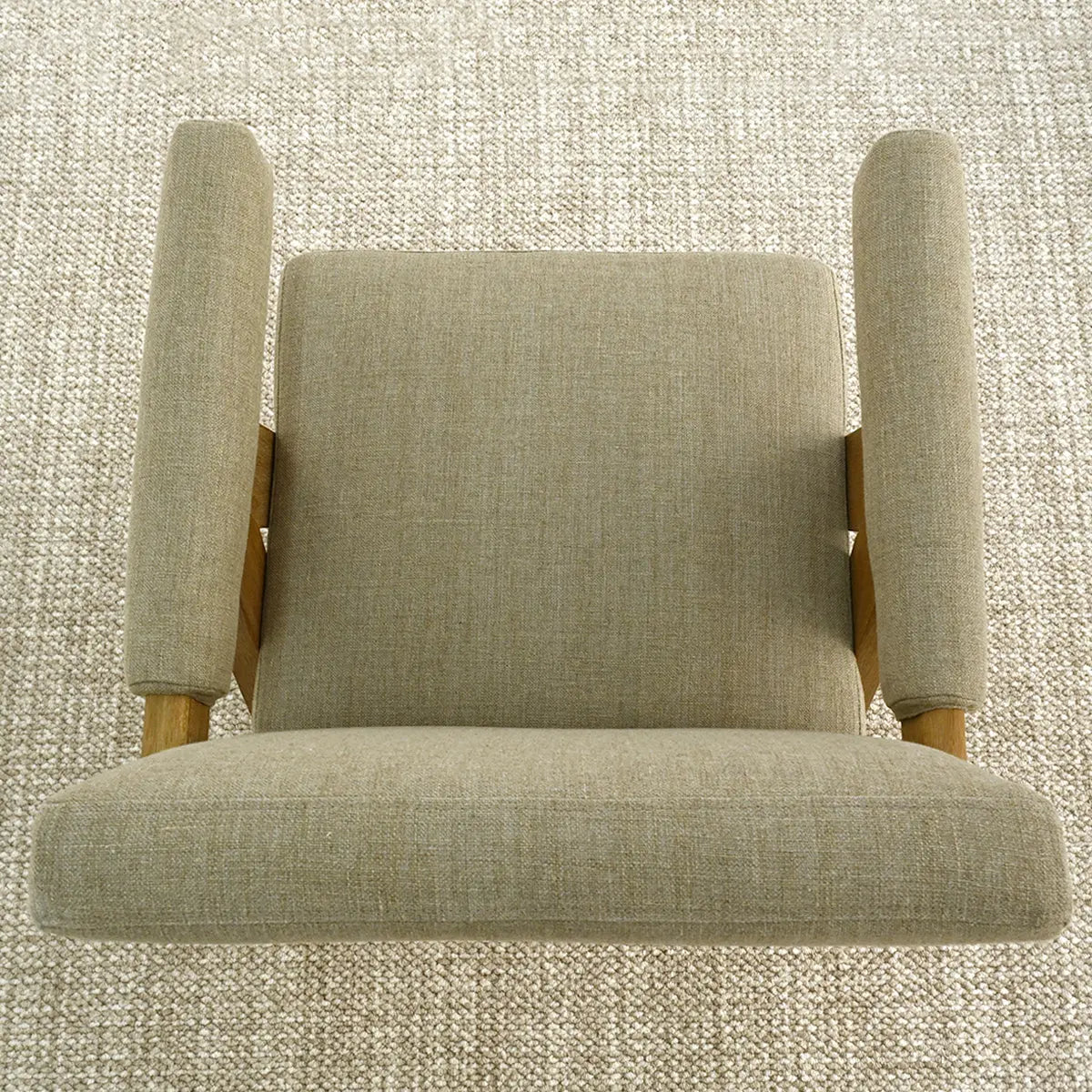 Top view of beige Morgan Mid Century Modern Upholstered Counter Stool with Arms on textured carpet.