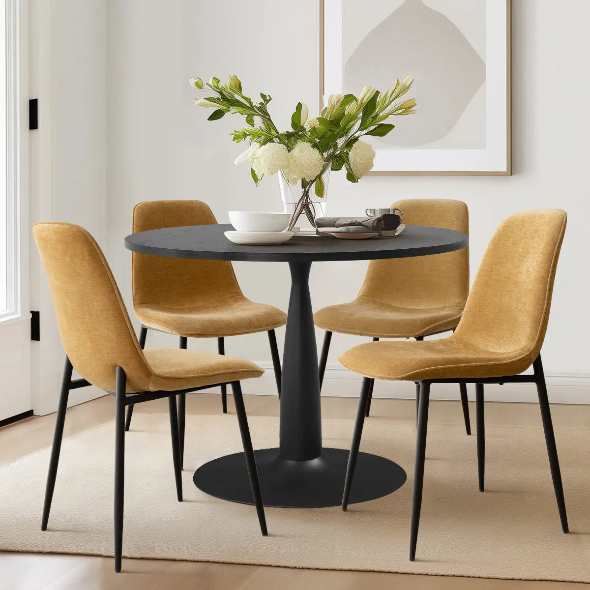 Haven & Oslo Dining Set with Black Round Table, mustard chairs, beige rug, and white walls.