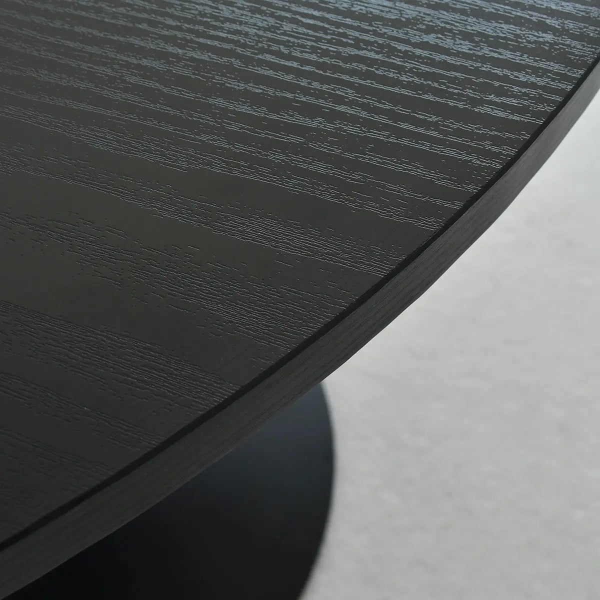 Close-up of Haven Modern Black Round Dining Table texture, showcasing elegant wood grain pattern.