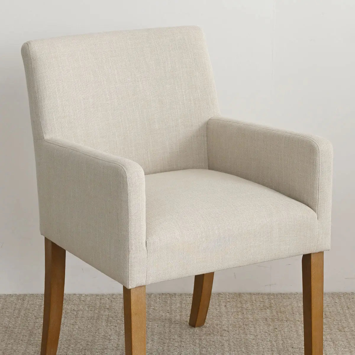 North Modern Boucle Upholstered Armchair on beige carpet, wooden legs, neutral room setting.