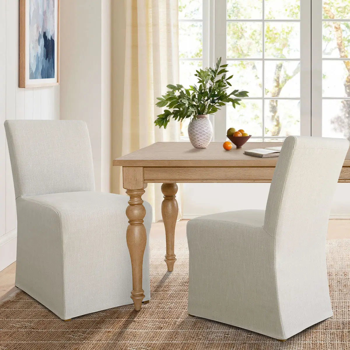 North Beige Dining Chair with Removable Slipcovers in a cozy dining room with wood table and rug.