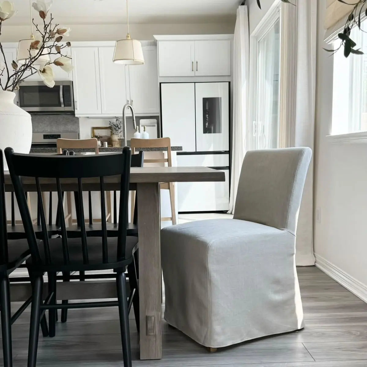 North Beige Upholstered Dining Chair with Removable Slipcovers in modern dining room with grey flooring.