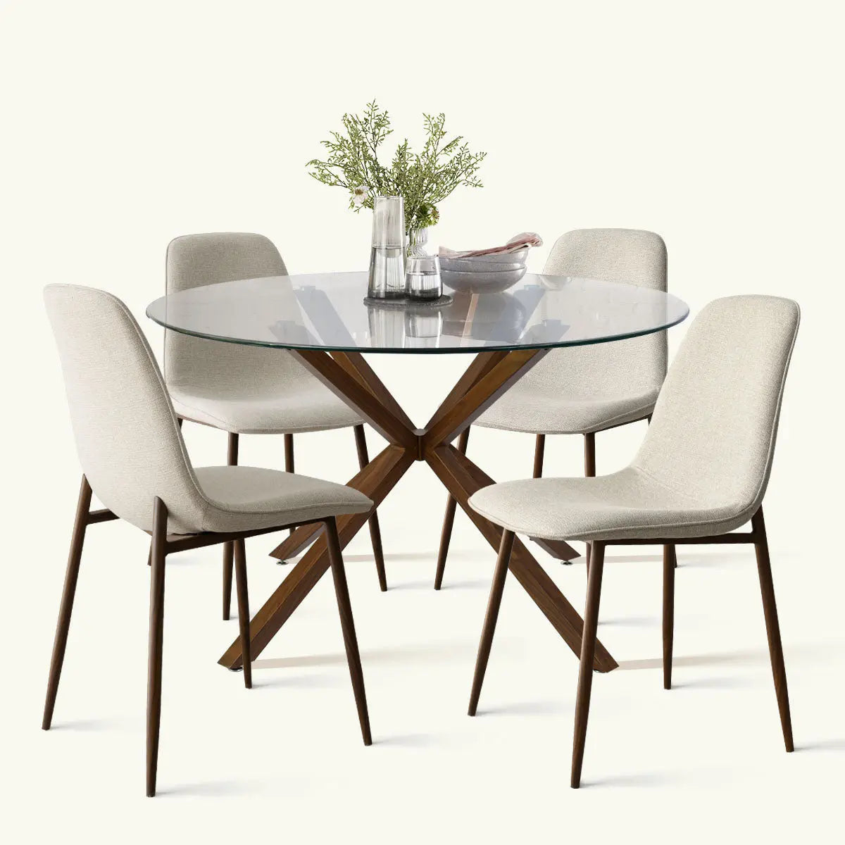 Oliver & Oslo Glass Round Dining Table Set with wood legs and beige chairs in dining room.