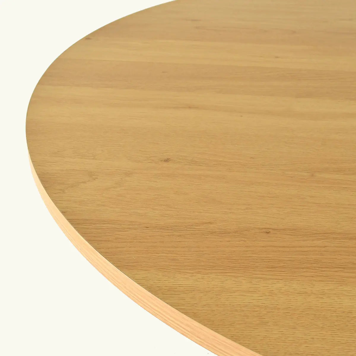 Close-up of wooden Oliver Modern Round Table top, showcasing natural grain and texture details.