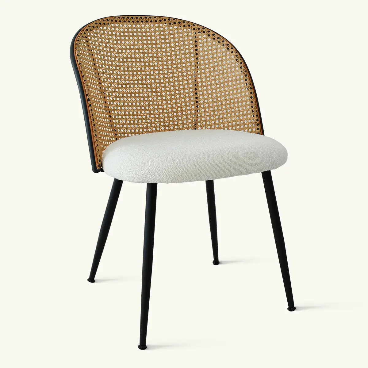 Oliver & Jules Rattan Round Dining Chair with black legs and woven backrest in neutral setting.