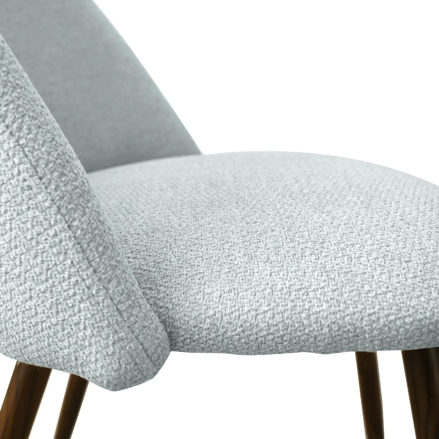 Close-up of upholstered chair from Oliver & Edwin Modern Dining Table Set with wood legs.
