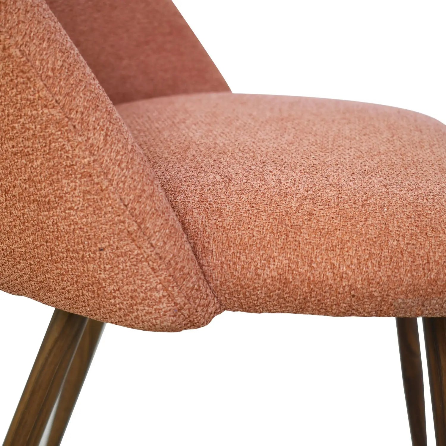 Close-up of Oliver & Edwin dining chair with pink upholstery; modern style and wooden legs.