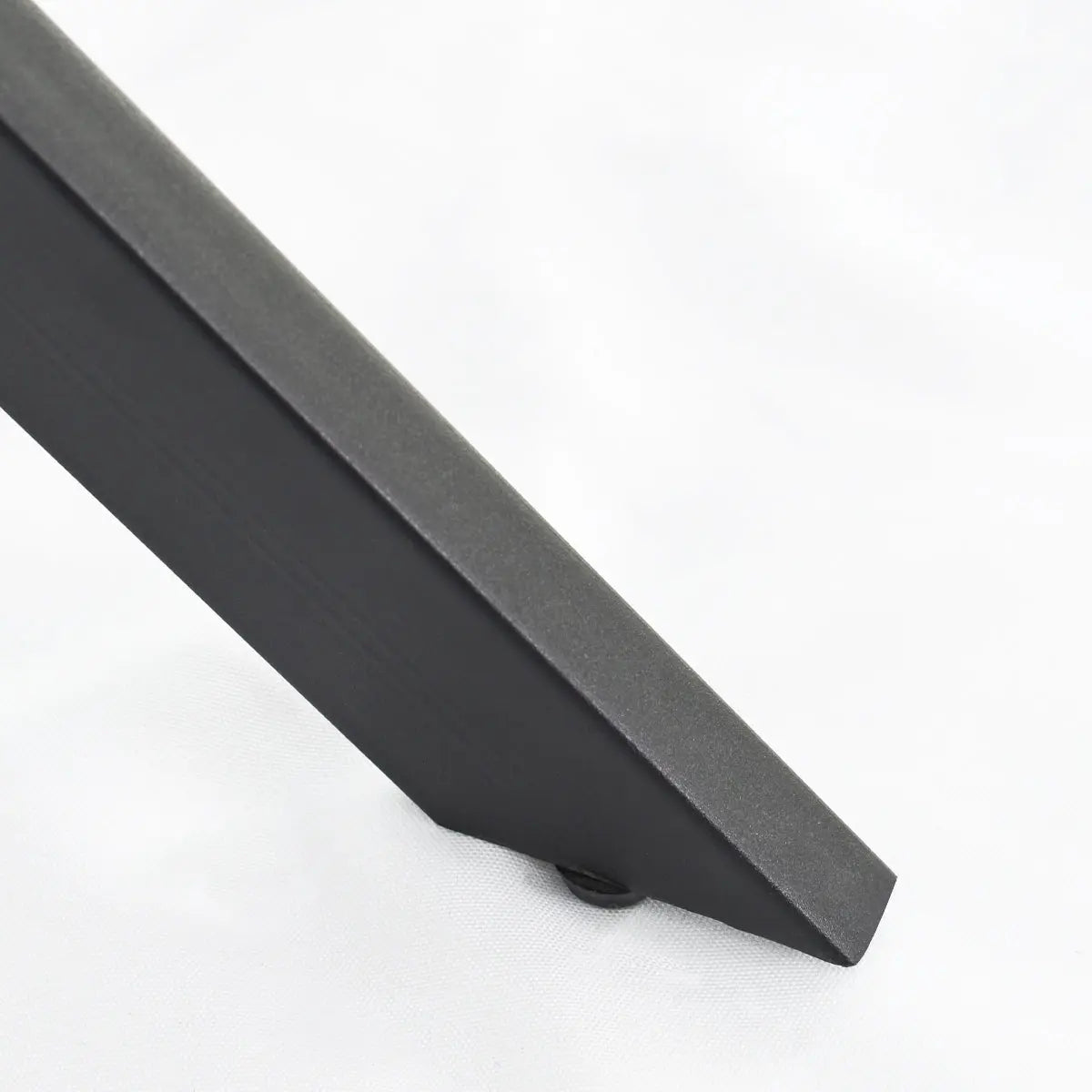 Jones Modern Black Round Dining Table leg detail, angle view.