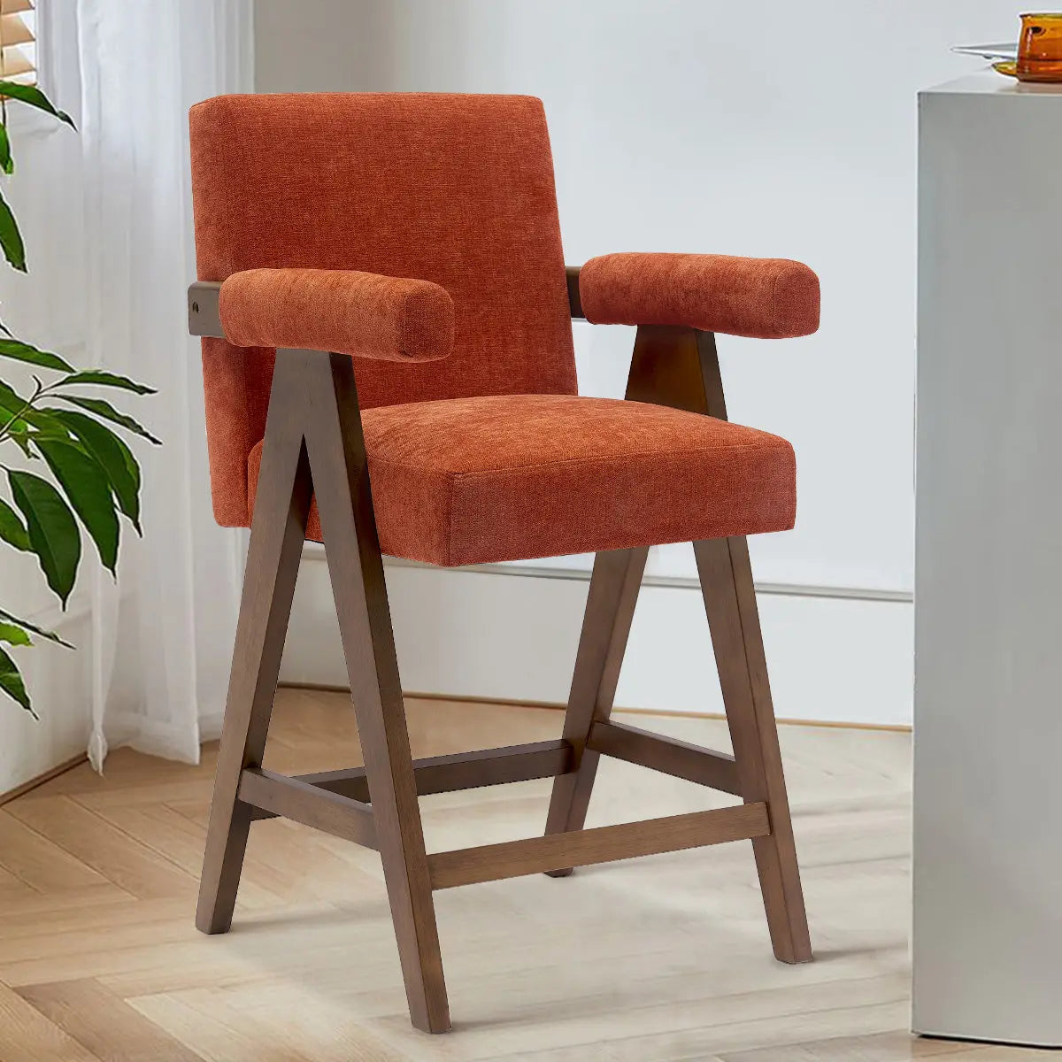 Morgan Mid Century Modern Upholstered Counter Stool with Arms on wood flooring in a bright room.