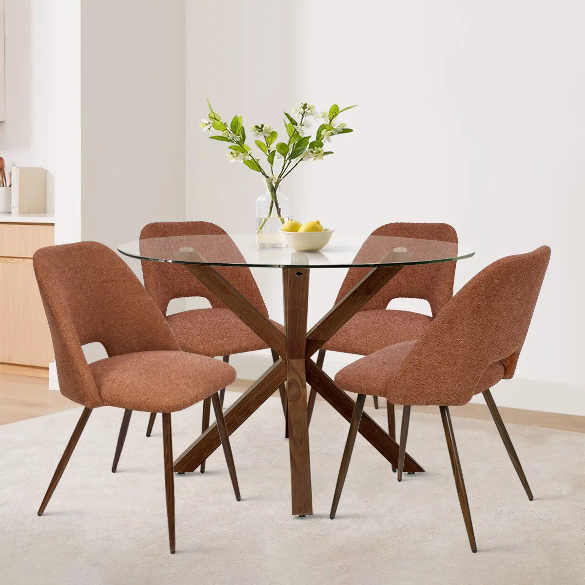 Oliver & Edwin dining set with glass top, orange chairs in modern dining room, light walls.