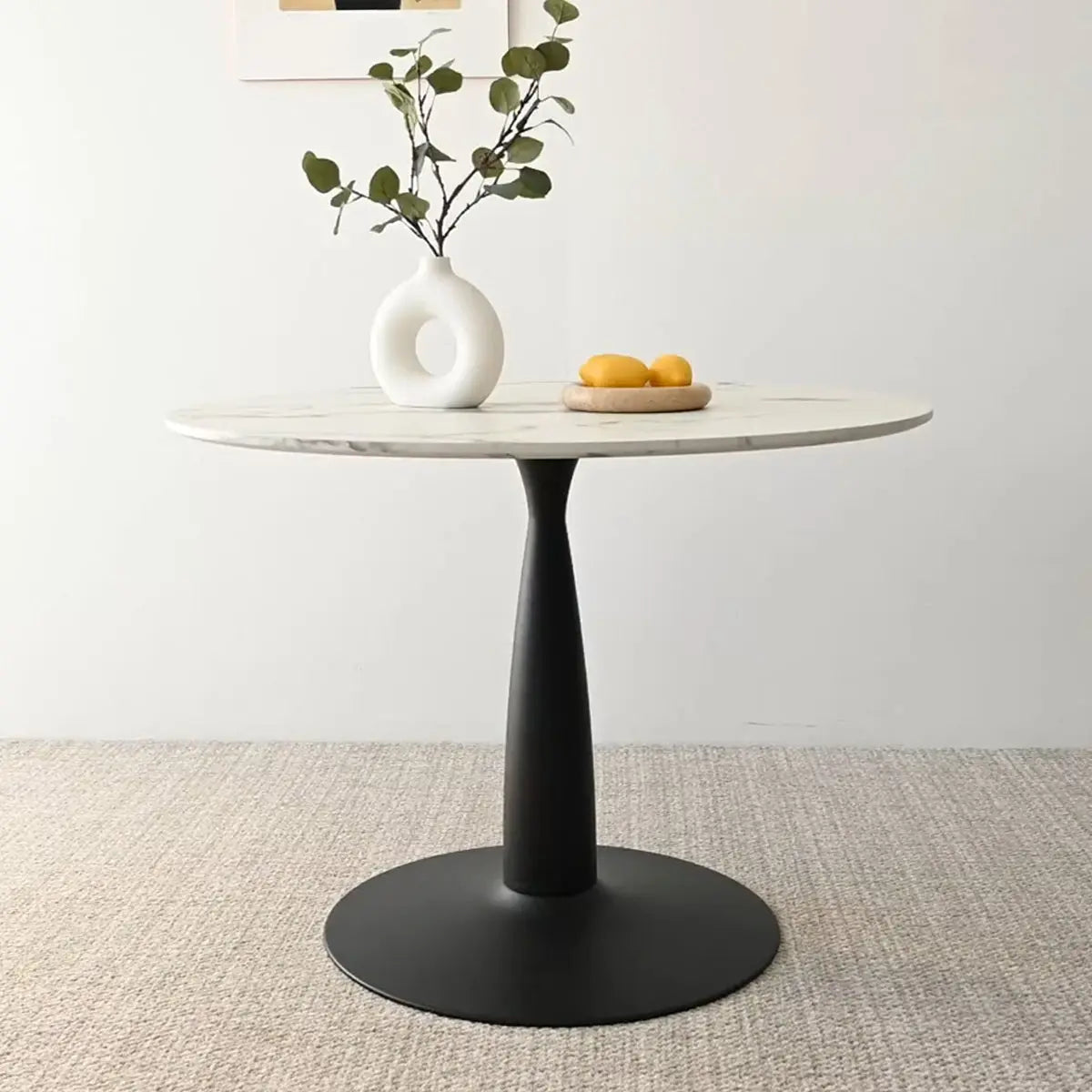 Harris Marble Top Round Pedestal Dining Table with beige carpet, minimalist decor, in dining setting.