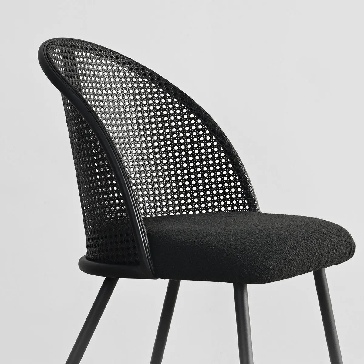 Lucca Black Rattan Boucle Dining Chair with curved backrest, modern design, no visible background.