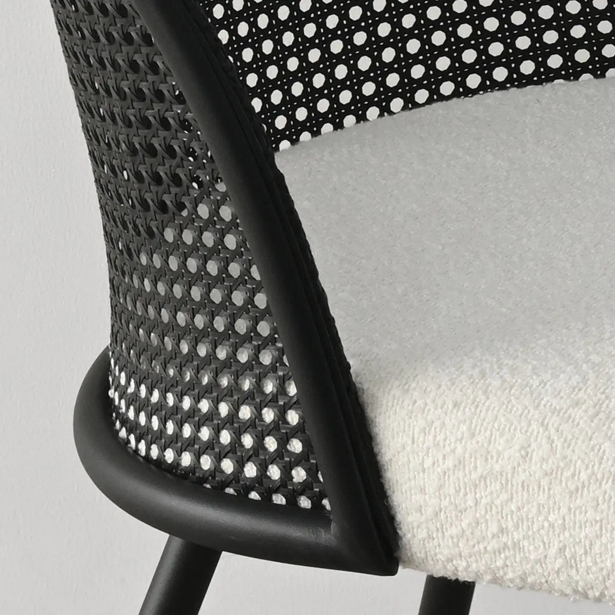 Lucca Black Rattan Boucle Dining Chair, close-up view; modern design with textured seat and backrest.