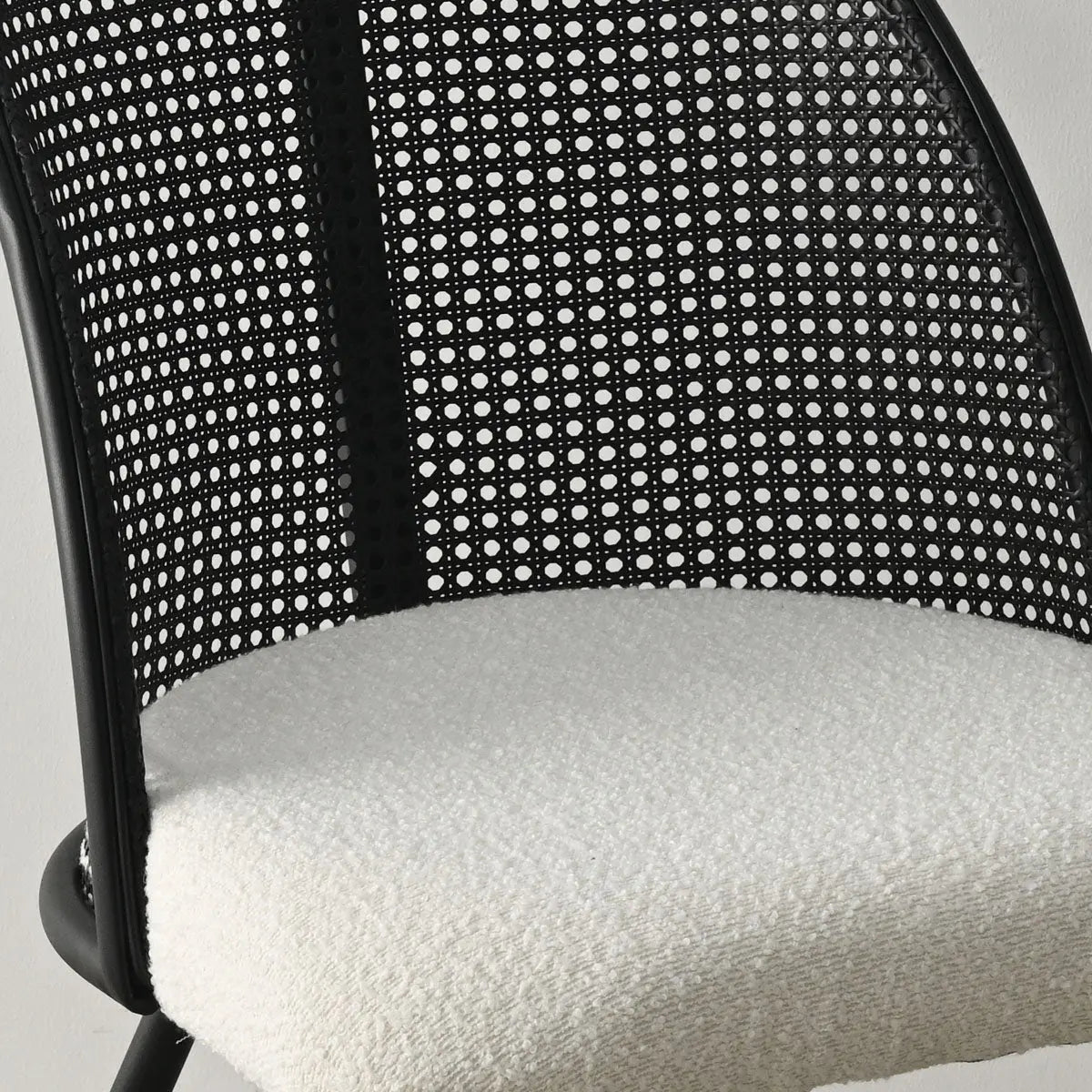 Lucca Black Rattan Boucle Dining Chair close-up; modern seat design with boucle fabric, black rattan.