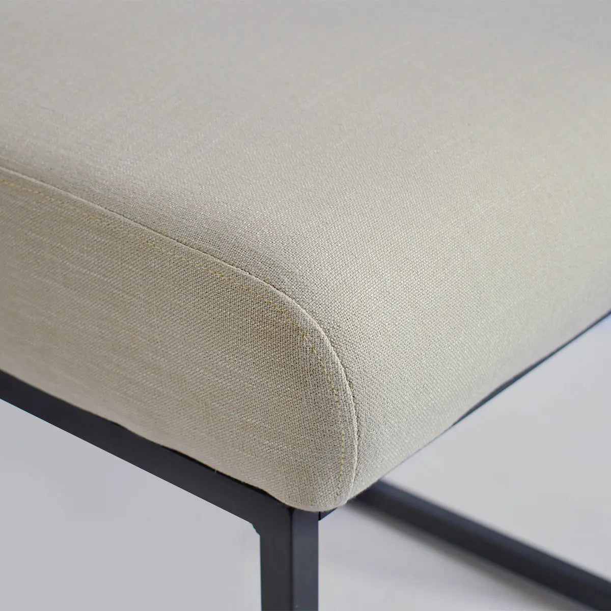 Close-up of Mason Modern upholstered counter stool with metal frame, beige fabric, contemporary design.