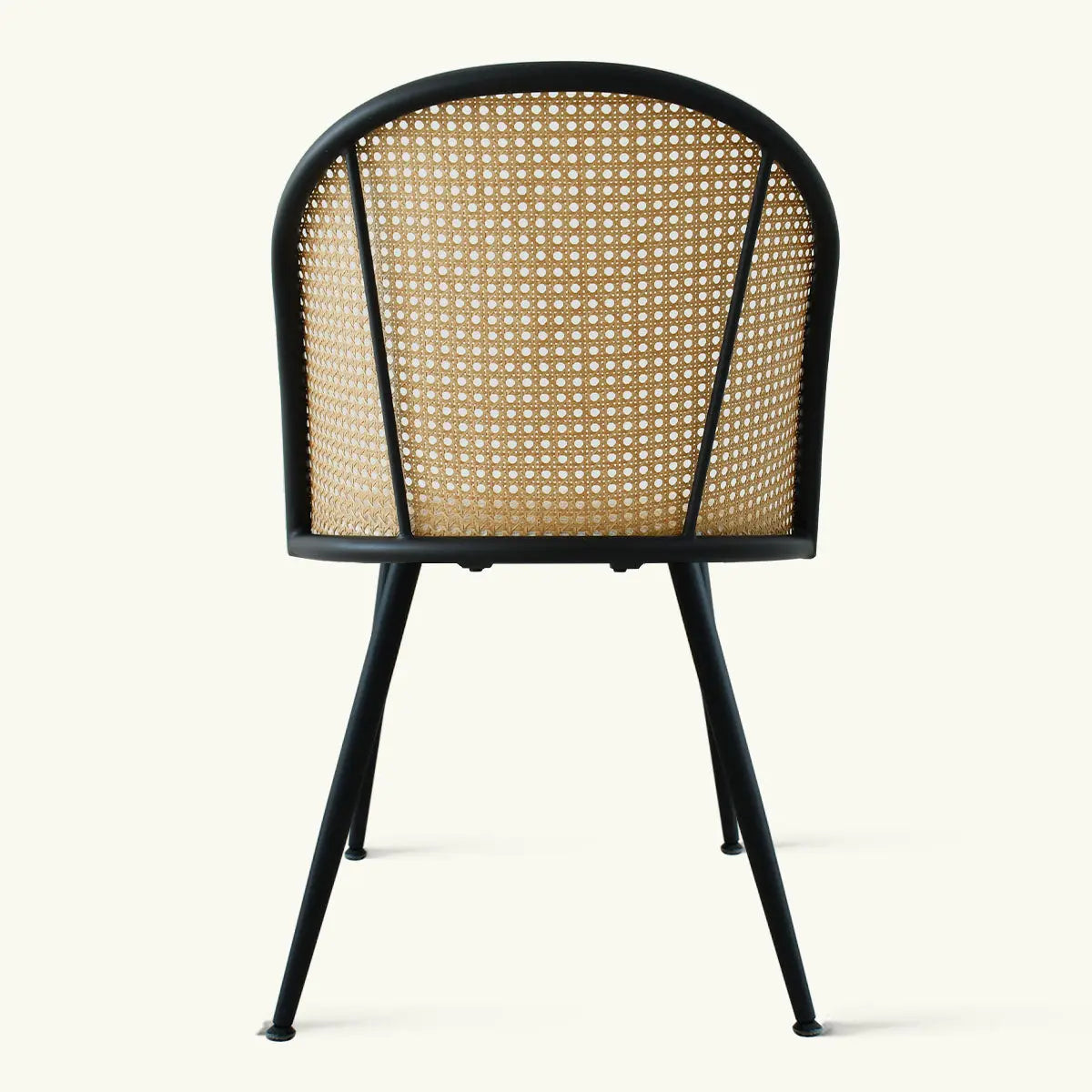 Oliver & Jules Rattan chair, black metal legs, featuring stylish design; suitable for modern dining rooms.